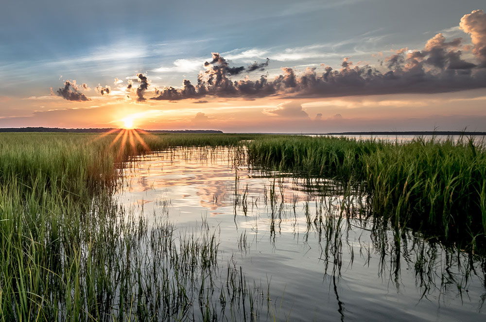 Sun setting over the marsh at high tide